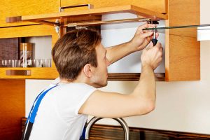 handyman updating old kitchen cabinets